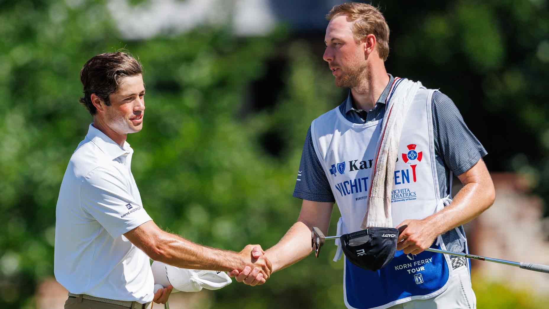 Cole Hammer shakes hands with his caddy after finishing the eighteenth hole during the third round of the Blue Cross and Blue Shield of Kansas Wichita Open 2025 at Crestview Country Club on June 21, 2025 in Wichita, Kansas.