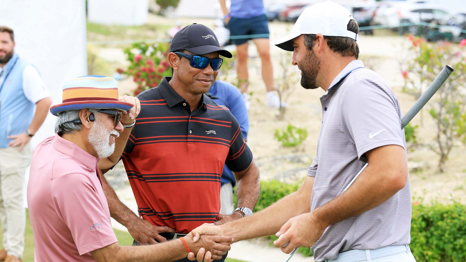 Dr. Pawan Munjal with Tiger Woods and Scottie Scheffler at the Hero World Challenge.