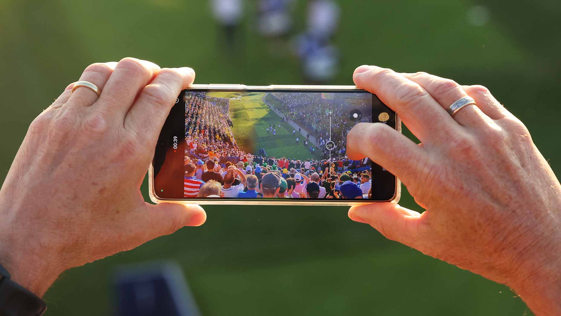 A fan watches Ryder Cup action on their phone