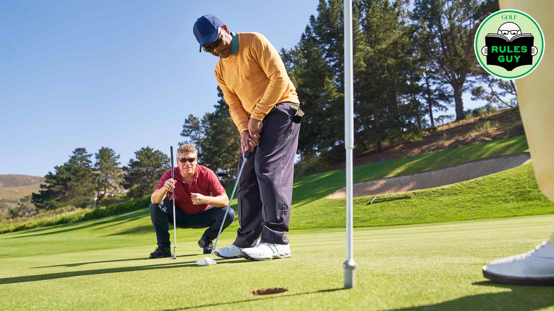 a golfer lines up a putt on the green